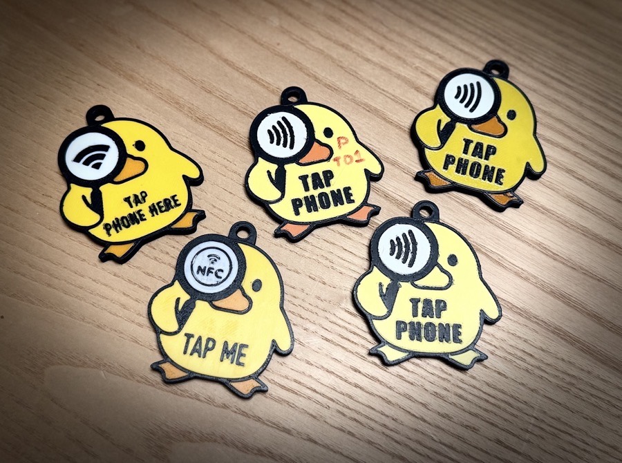 Five 3D-printed Where the Duck tag prototypes laid out on a wood floor